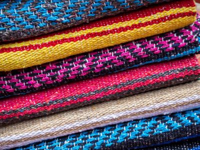 Colorful striped woollen rugs selling on a street